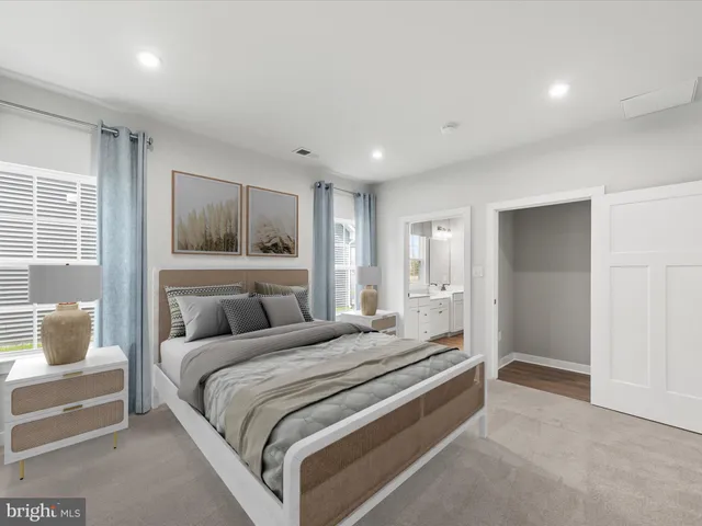 a bathroom with a granite countertop sink a mirror and a bathtub