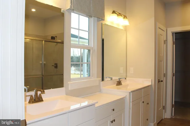 a bathroom with a sink double vanity and a mirror