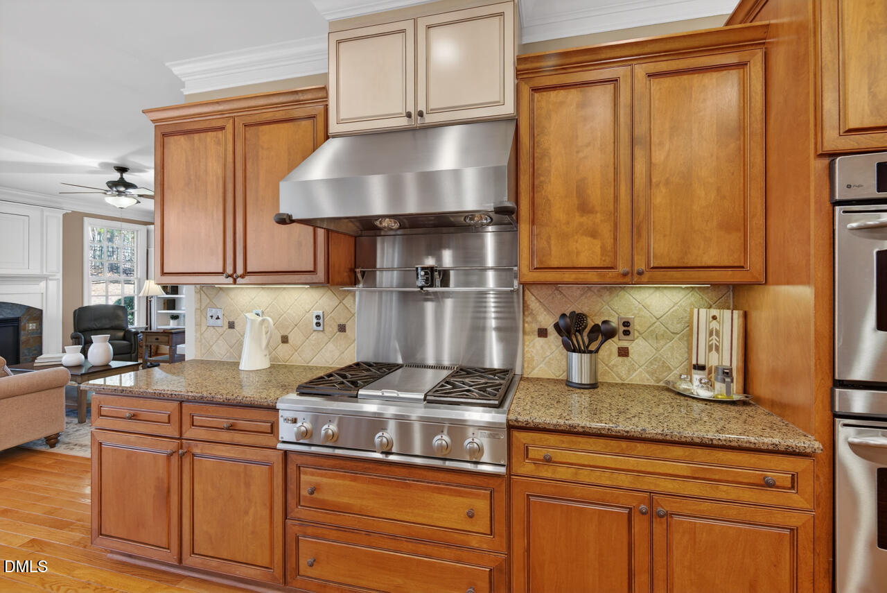 2545 Bittersweet Drive Durham, NC 27705 - Photo 21 of 91 a kitchen with stainless steel appliances granite countertop a sink stove and cabinets