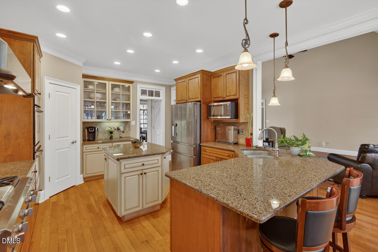 2545 Bittersweet Drive Durham, NC 27705 - Photo 23 of 91 a kitchen with stainless steel appliances granite countertop a kitchen island a stove and a refrigerator