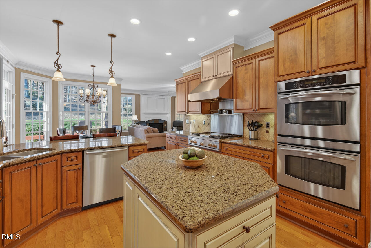 2545 Bittersweet Drive Durham, NC 27705 - Photo 32 of 91 a kitchen with stainless steel appliances granite countertop a sink stove and refrigerator