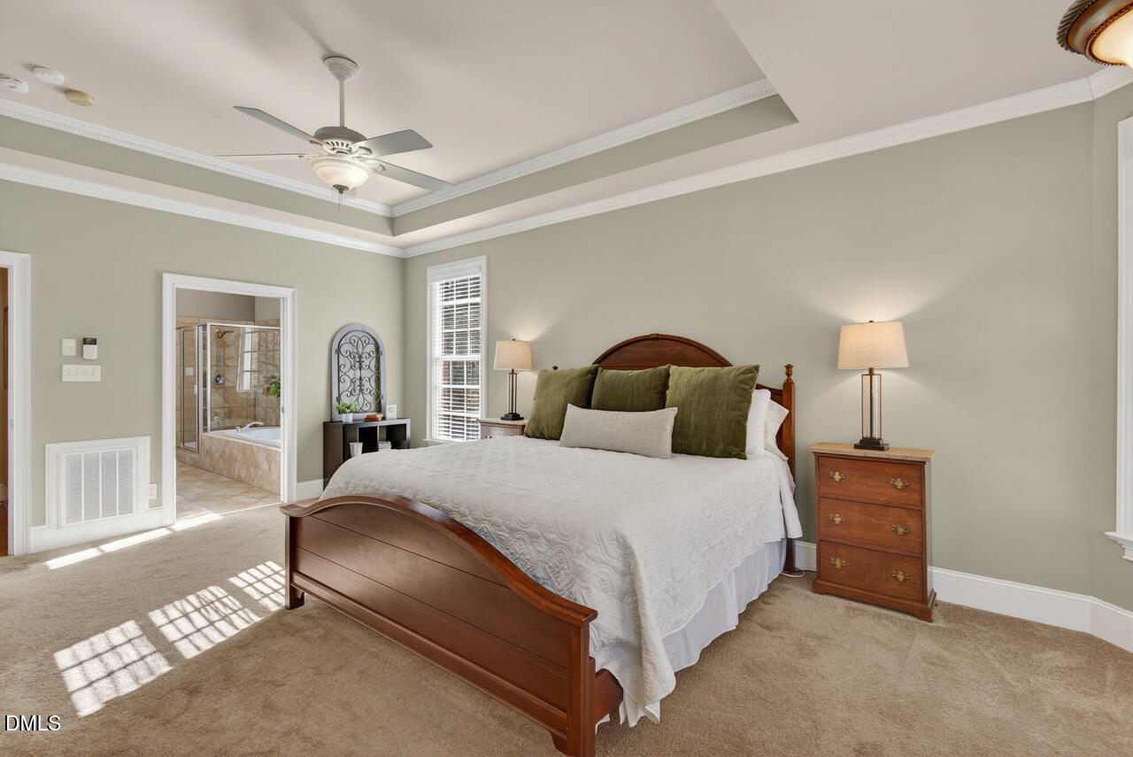 2545 Bittersweet Drive Durham, NC 27705 - Photo 44 of 91 a bedroom with a large bed and a chandelier