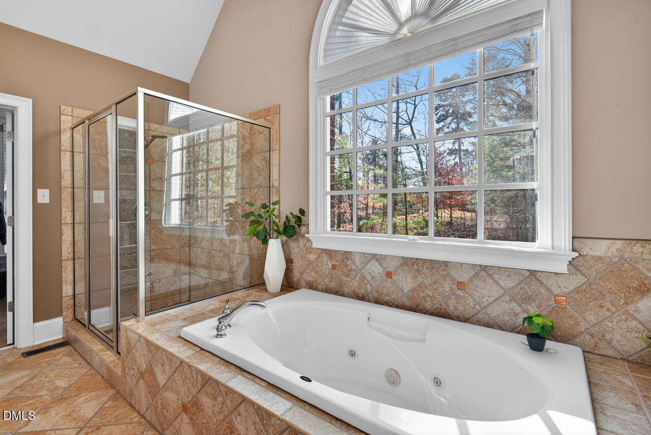 2545 Bittersweet Drive Durham, NC 27705 - Photo 48 of 91 a bathroom with a bathtub and shower