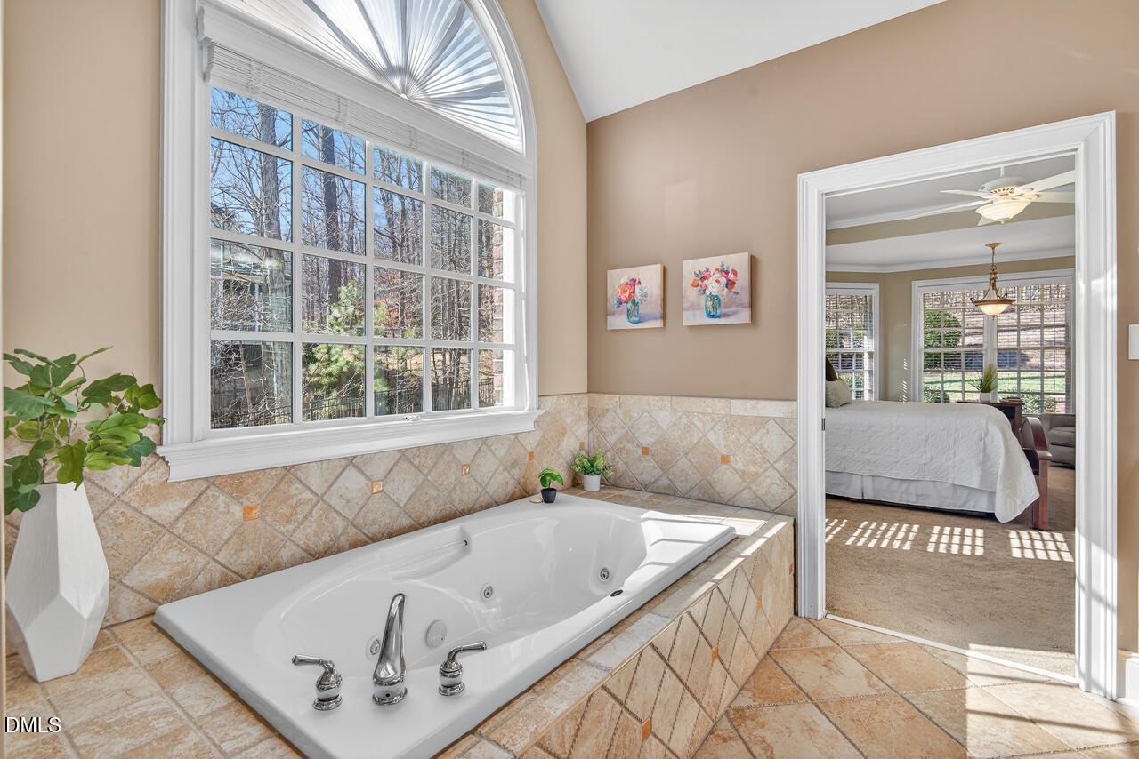 2545 Bittersweet Drive Durham, NC 27705 - Photo 49 of 91 a bath tub sitting in a bathroom next to a window