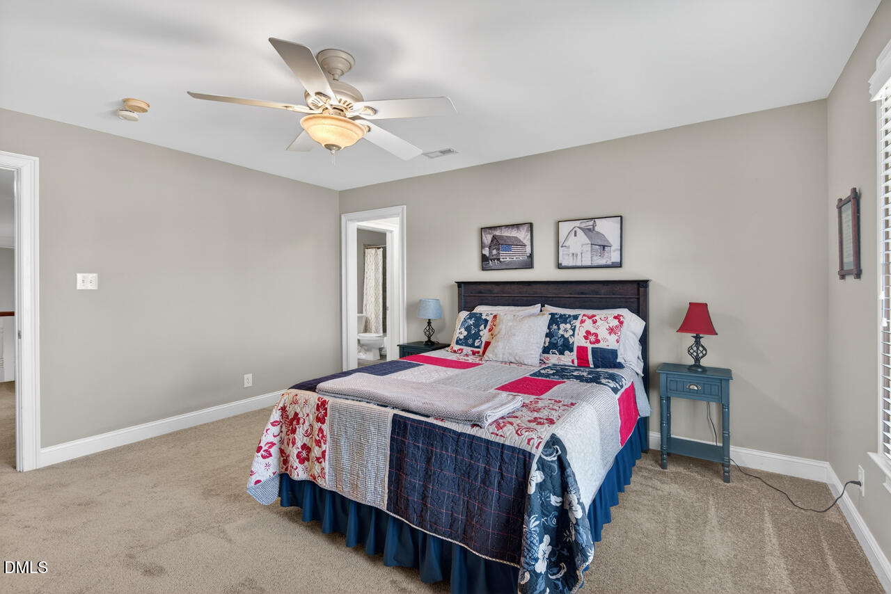 2545 Bittersweet Drive Durham, NC 27705 - Photo 59 of 91 a bedroom with a bed and a chandelier