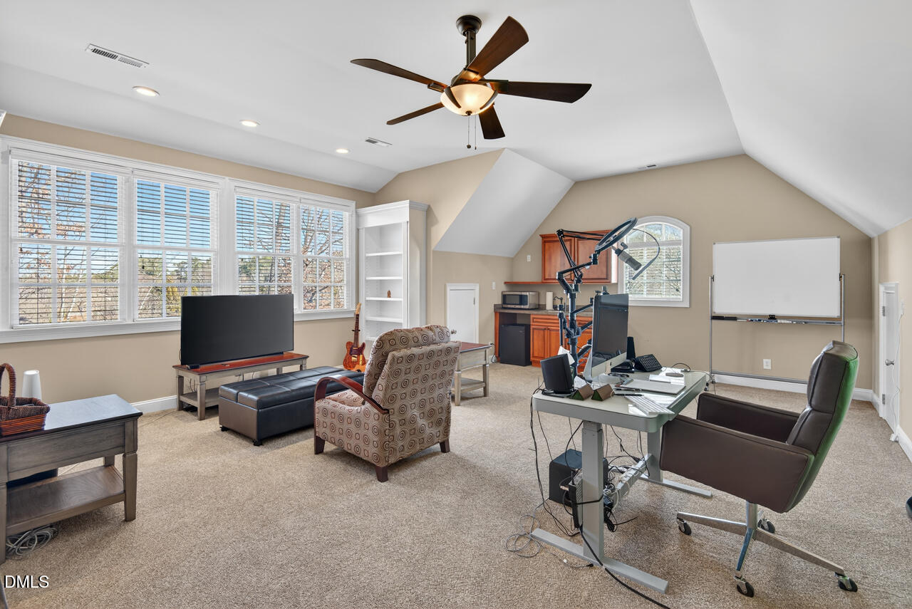 2545 Bittersweet Drive Durham, NC 27705 - Photo 60 of 91 a living room with furniture and a flat screen tv
