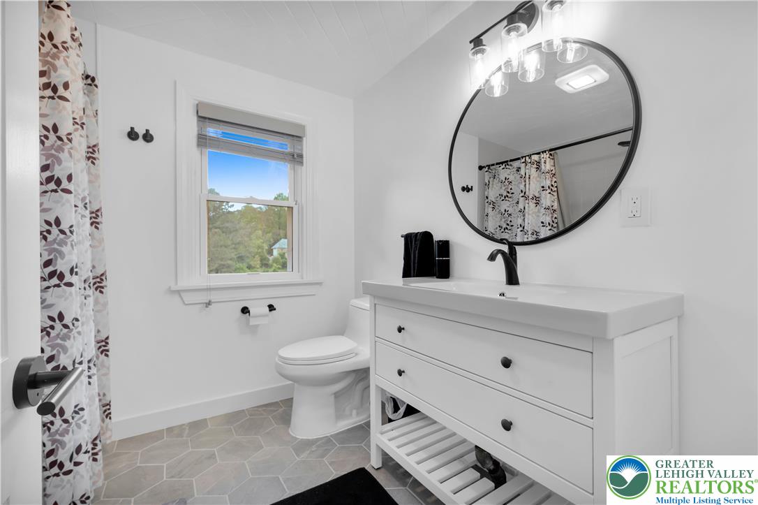 2242 Church Road Bethlehem, PA 18015 - Photo 47 of 74 a bathroom with a toilet a sink and a mirror
