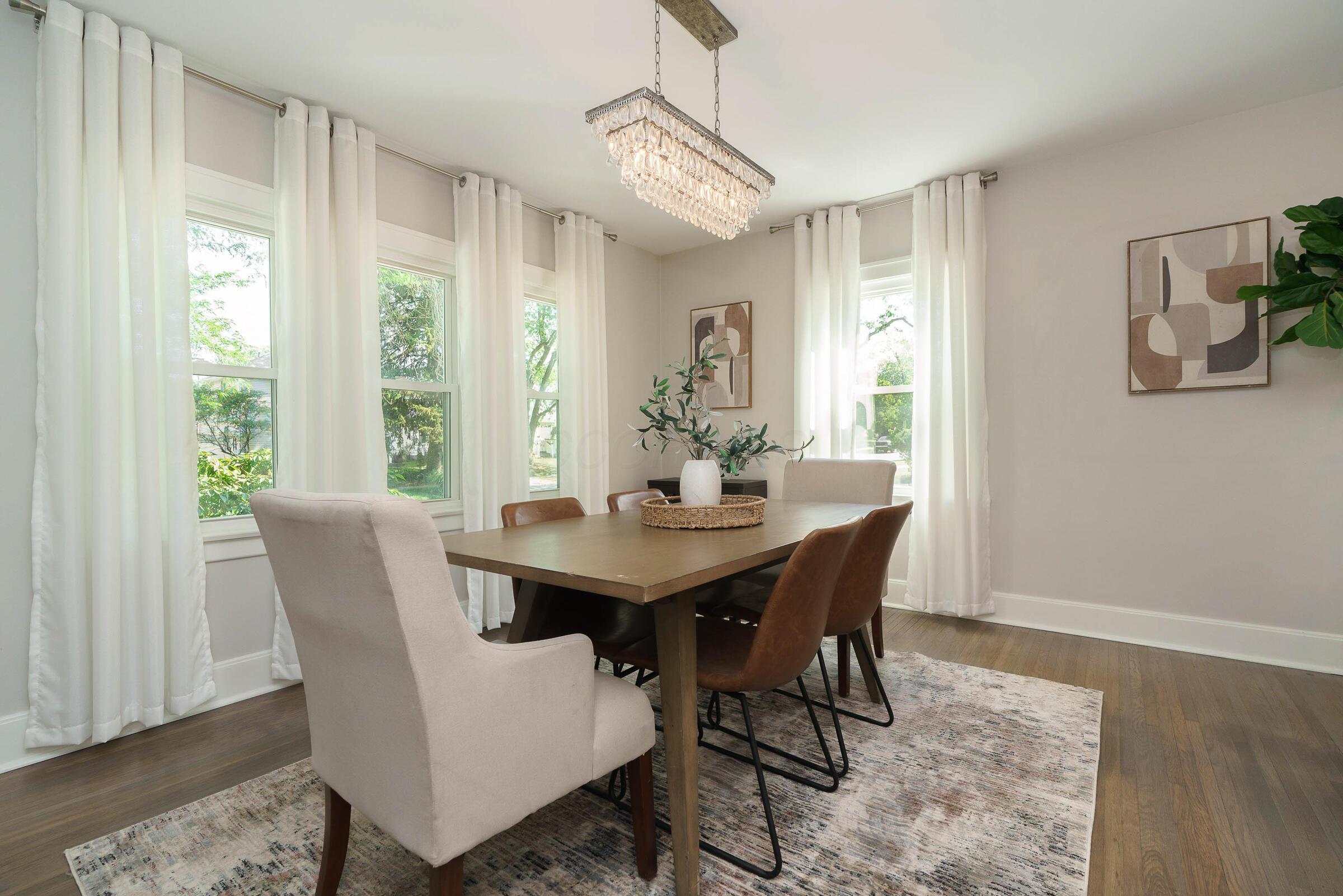 163 Garden Road Columbus, OH 43214 - Photo 12 of 46 Elegant dining room with chandelier and brilliant natural light is ideal for nightly dinners or special holiday feasts.