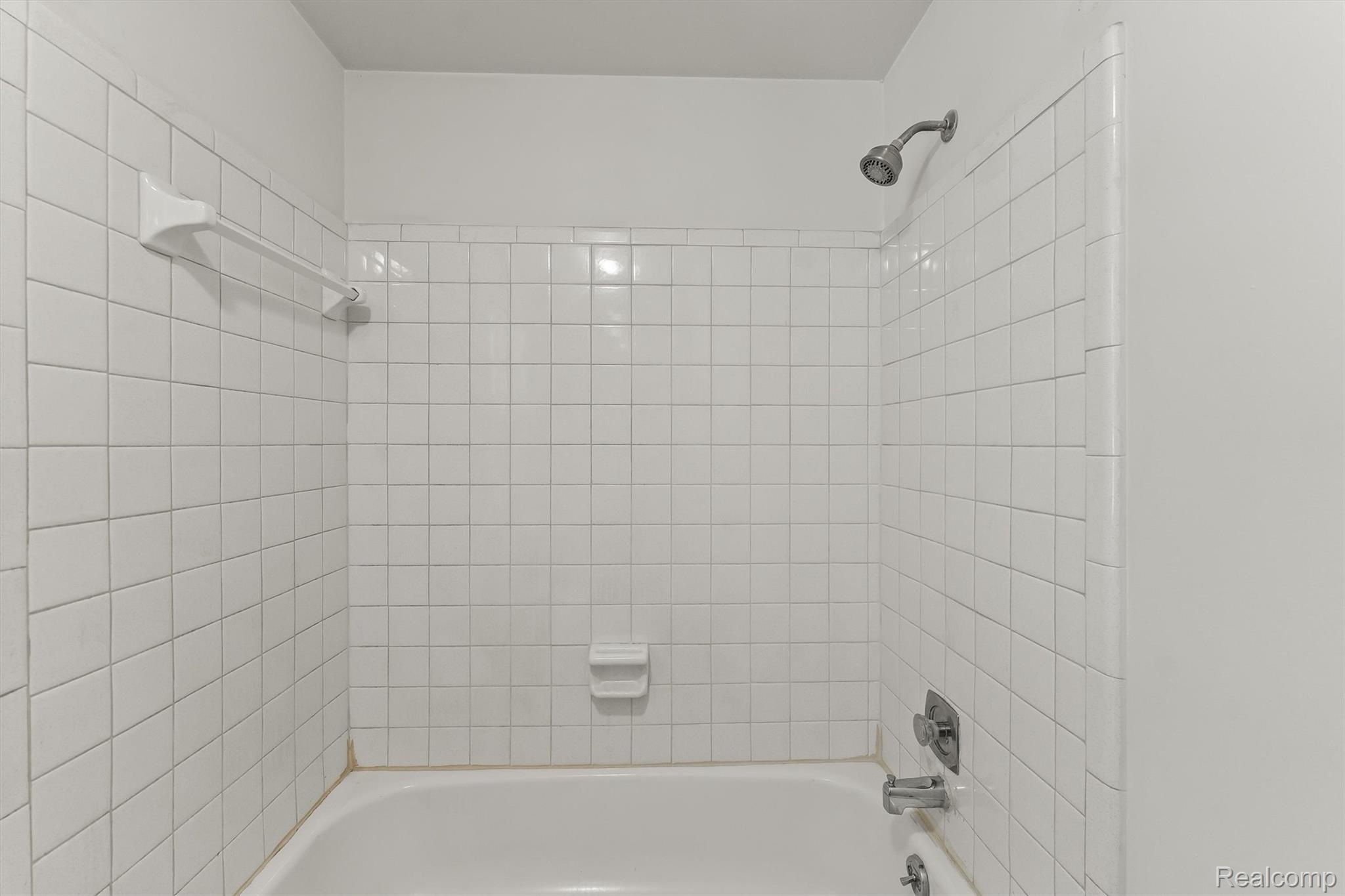 2118 Rutgers Drive Troy, MI 48085 - Photo 19 of 39 White ceramic tile shower surround with integrated bathtub