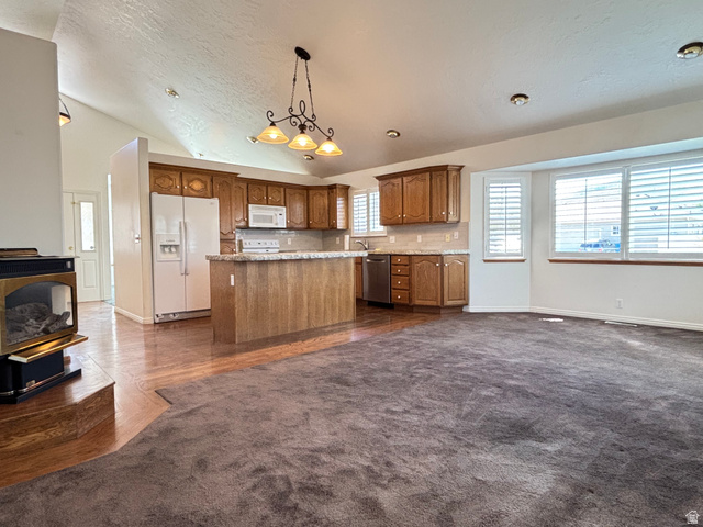 798 South 600 East Payson, UT 84651 - Photo 13 of 31 Open-concept living area featuring a kitchen with wood cabinetry, light-toned countertops, and a central island