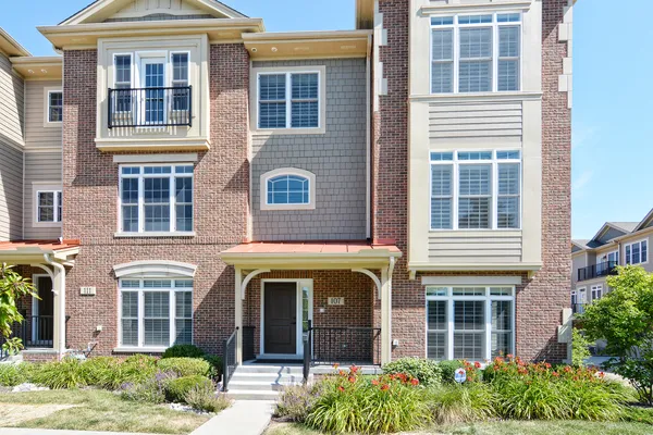 a front view of a house with many windows