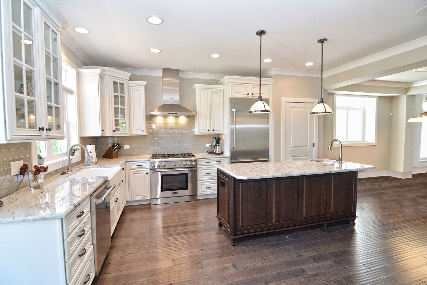 107 Stevens Street Geneva, IL 60134 - Photo 12 of 24 a large kitchen with stainless steel appliances granite countertop a sink a stove and a refrigerator