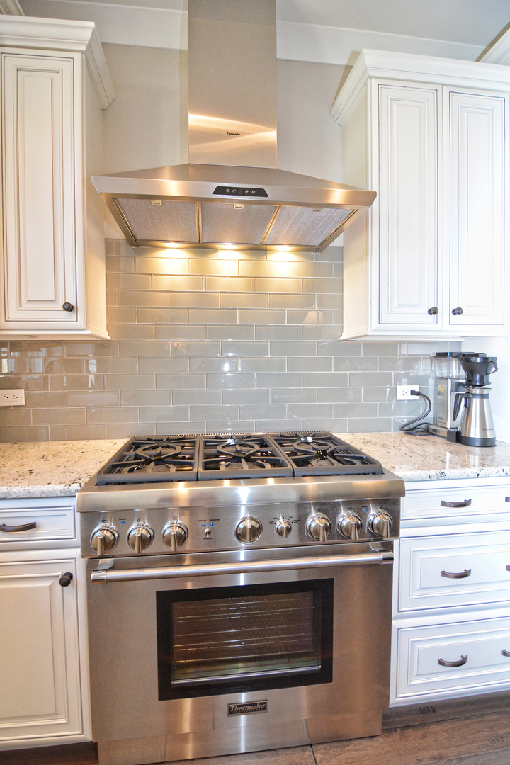 107 Stevens Street Geneva, IL 60134 - Photo 13 of 24 a stove top oven sitting inside of a kitchen