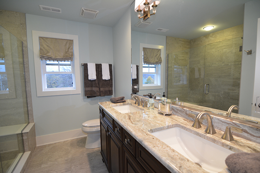 107 Stevens Street Geneva, IL 60134 - Photo 17 of 24 a bathroom with a granite countertop double vanity sink a mirror and a toilet