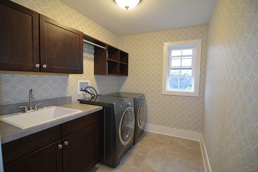107 Stevens Street Geneva, IL 60134 - Photo 19 of 24 a bathroom with a sink a washer and dryer