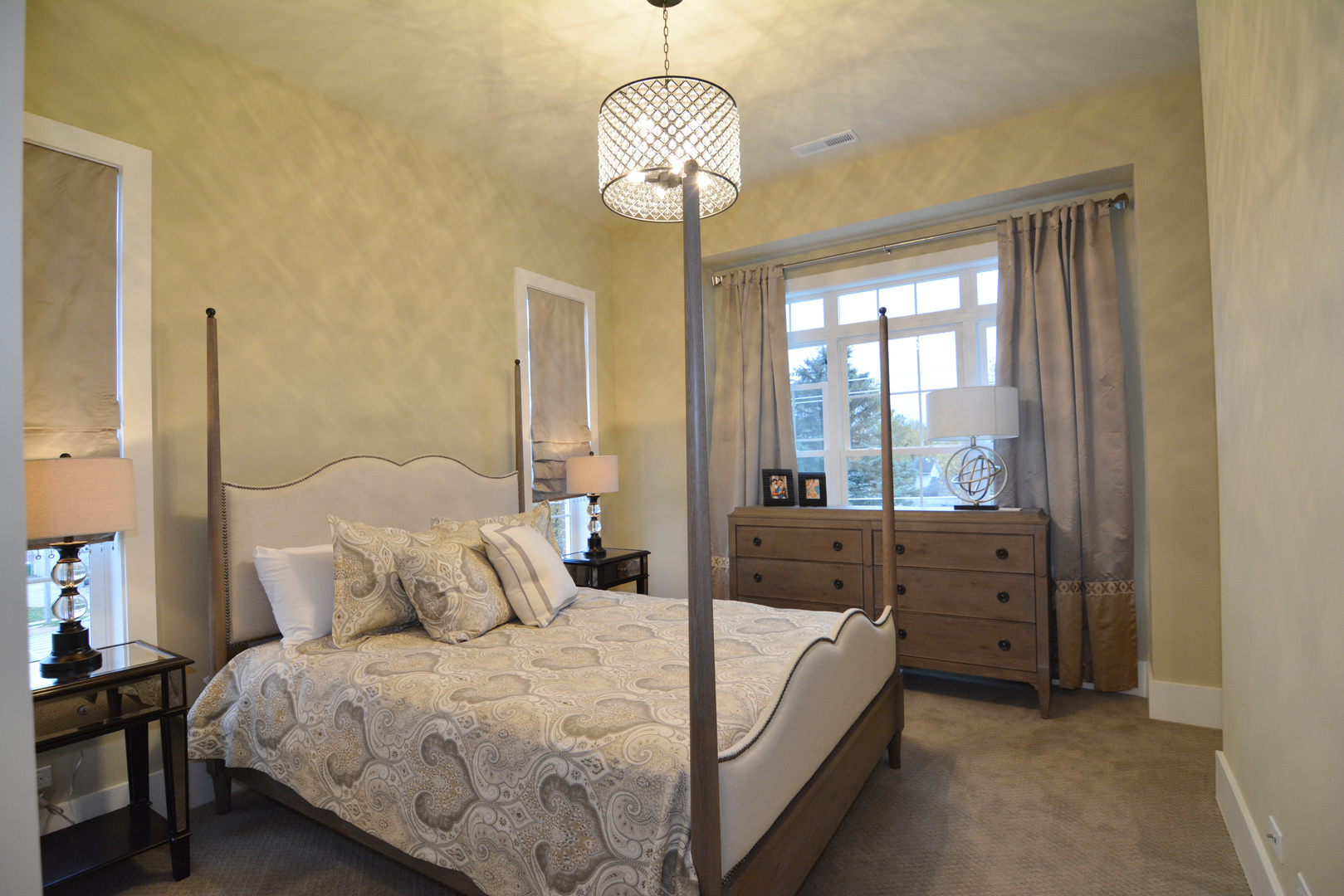 107 Stevens Street Geneva, IL 60134 - Photo 20 of 24 a bed room with a bed and a chandelier