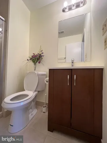 a bathroom with a sink toilet and mirror