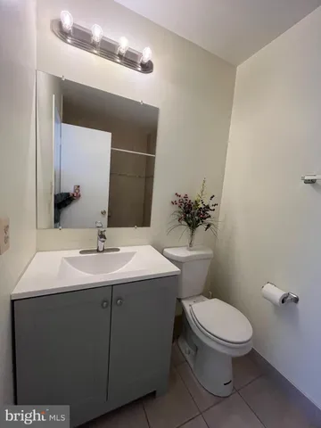 a bathroom with a toilet a sink and mirror