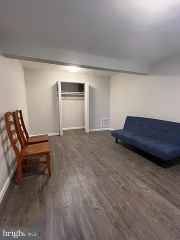 a room with a bench and a wooden floor