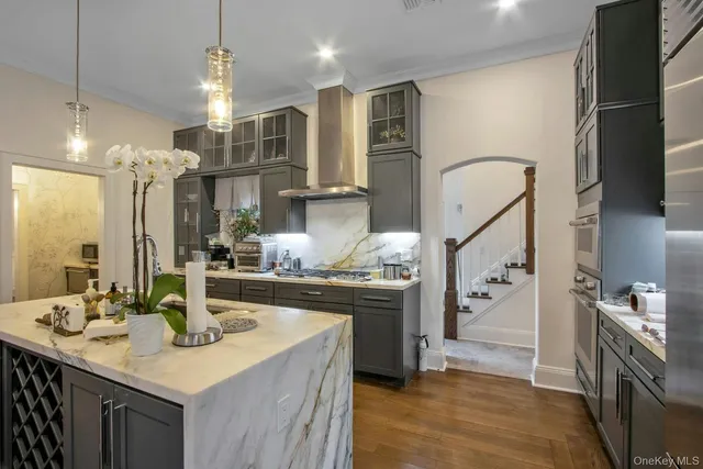 a kitchen with stainless steel appliances granite countertop a sink a stove and a refrigerator