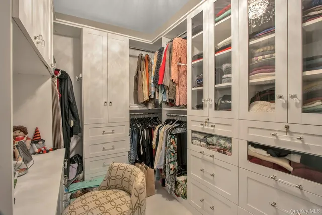 a view of walk in closet with clothes and shoes