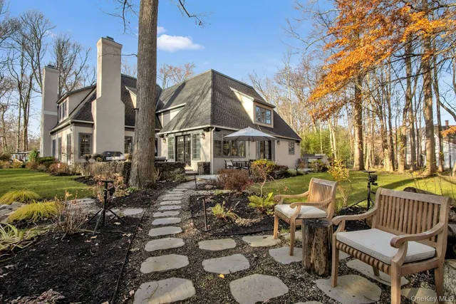 a view of a patio with couches table and chairs and potted plants