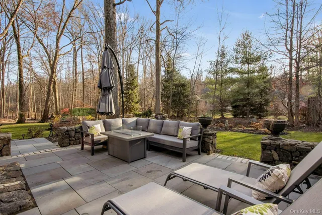 a view of a patio with couches and a fire pit