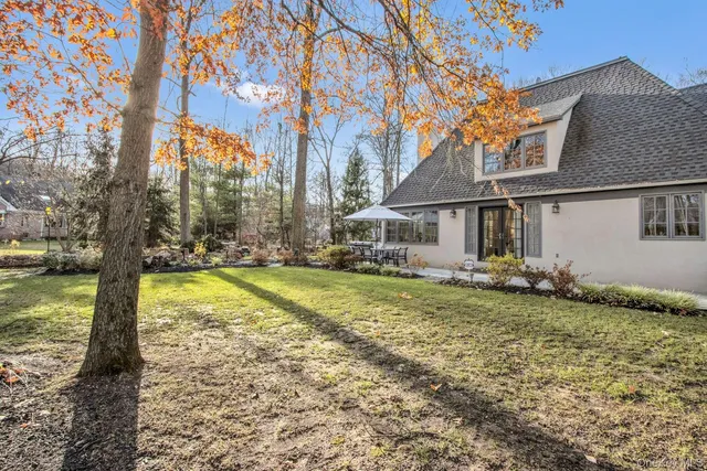 a view of a house with swimming pool and sitting area