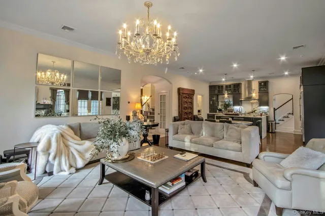 a living room with furniture and a chandelier