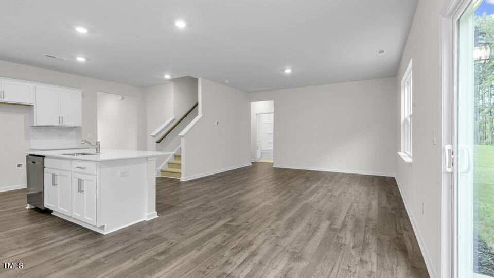 818 Comice Pear Way Willow Spring, NC 27592 - Photo 12 of 44 a view of an empty room with wooden floor and a window