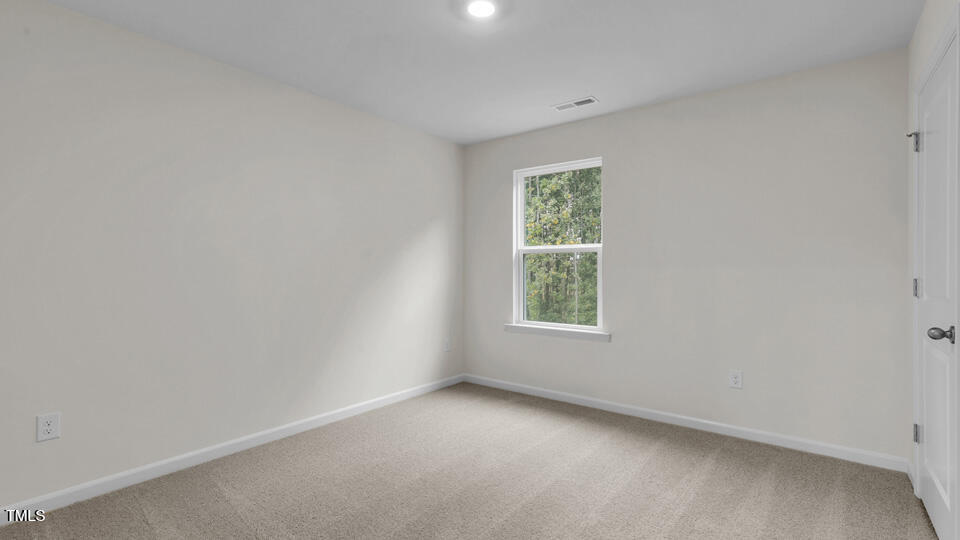 818 Comice Pear Way Willow Spring, NC 27592 - Photo 22 of 44 an empty room with a window