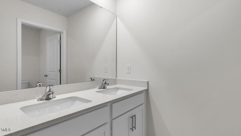 818 Comice Pear Way Willow Spring, NC 27592 - Photo 32 of 44 a bathroom with a sink and a mirror