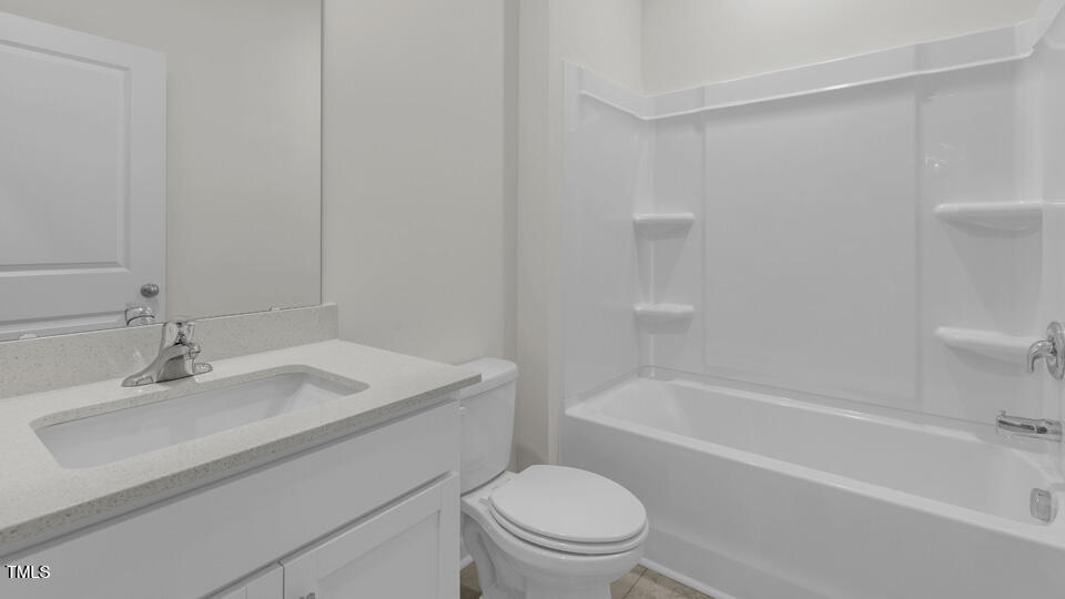 818 Comice Pear Way Willow Spring, NC 27592 - Photo 33 of 44 a bathroom with a sink toilet vanity and bathtub