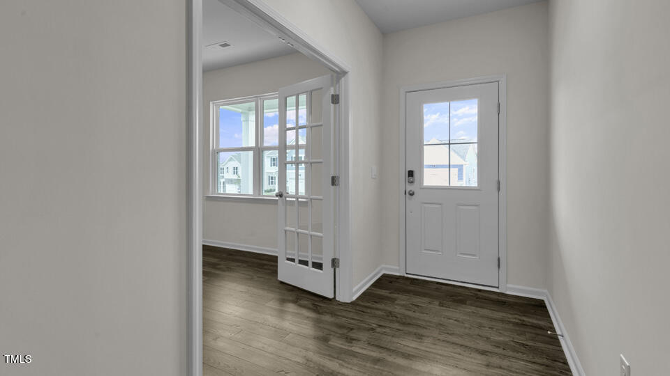 818 Comice Pear Way Willow Spring, NC 27592 - Photo 5 of 44 an empty room with wooden floor and windows