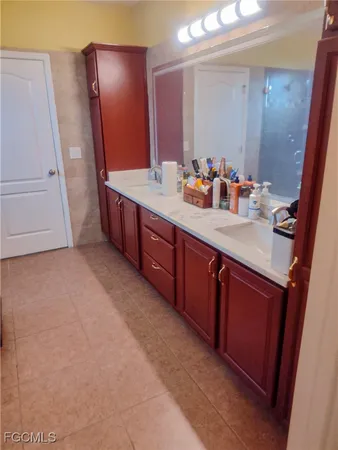 a spacious bathroom with a double vanity sink and a mirror