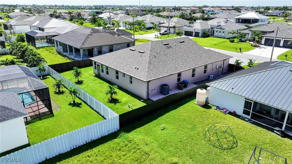 an aerial view of a house with a garden and pool