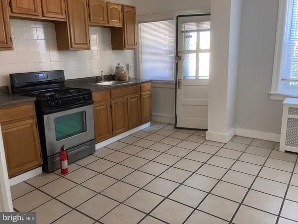 a kitchen with stainless steel appliances a sink stove and cabinets