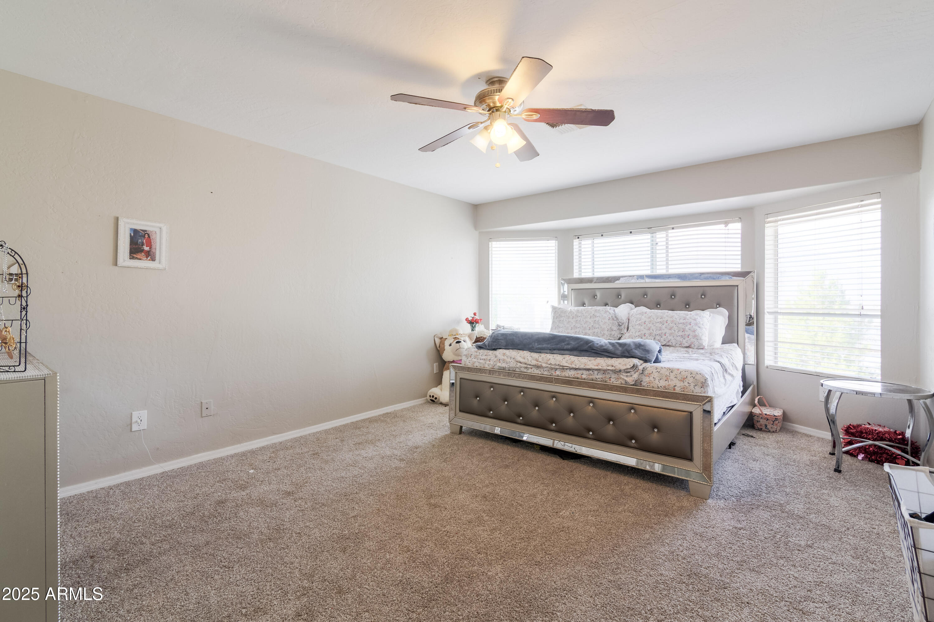 3755 East Broadway Road, Unit 36 Mesa, AZ 85206 - Photo 11 of 24 a bedroom with a bed and a chandelier