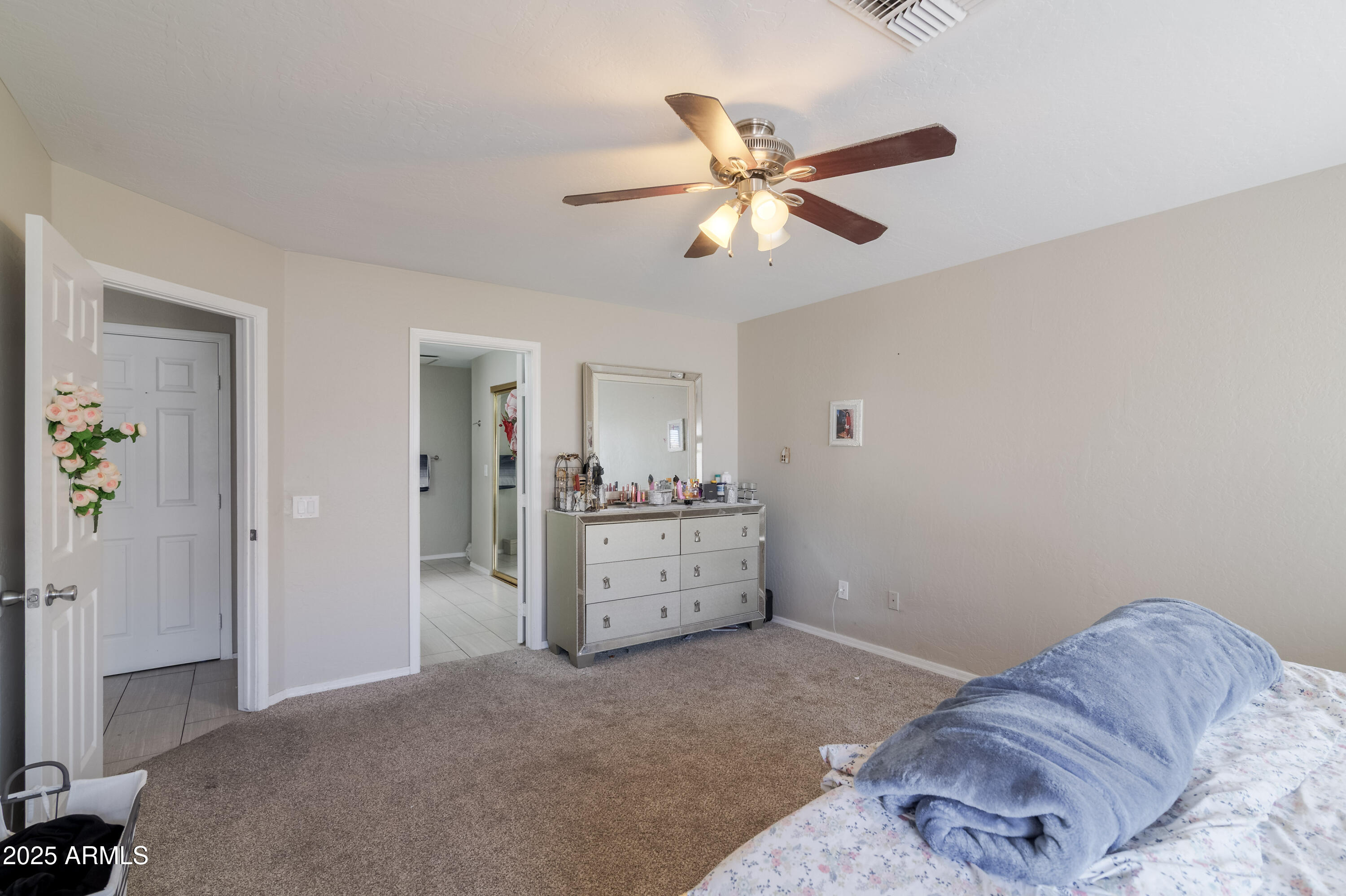 3755 East Broadway Road, Unit 36 Mesa, AZ 85206 - Photo 12 of 24 a bedroom with a bed and a chandelier