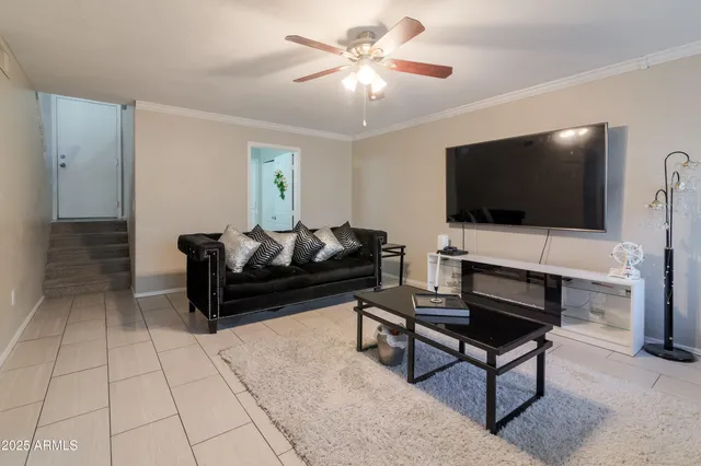 a living room with furniture and a flat screen tv