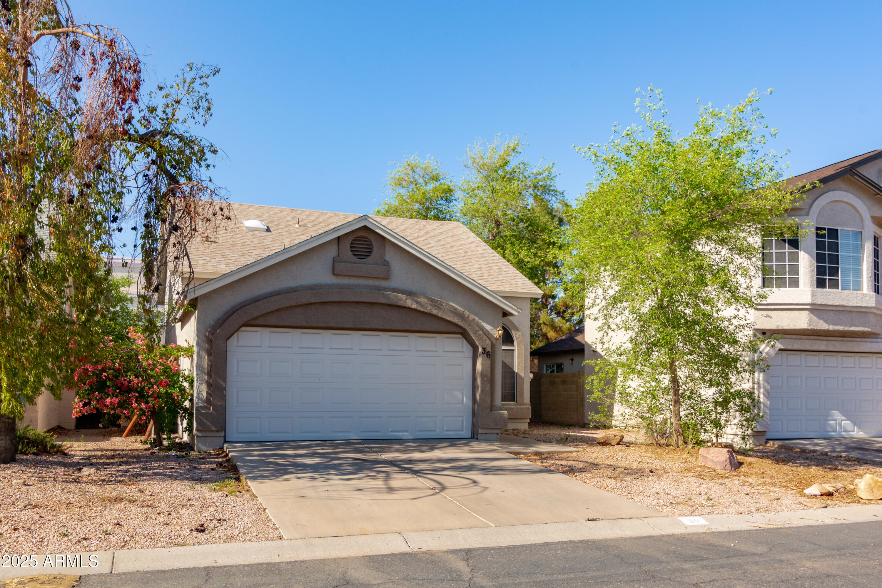 3755 East Broadway Road, Unit 36 Mesa, AZ 85206 - Photo 2 of 24 a front view of a house with a yard