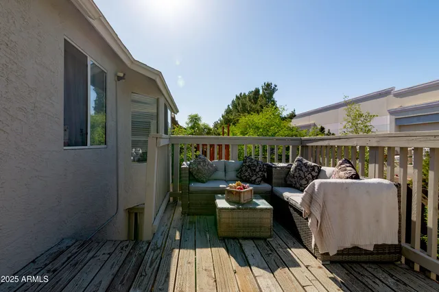 a view of balcony with wooden floor and seating space