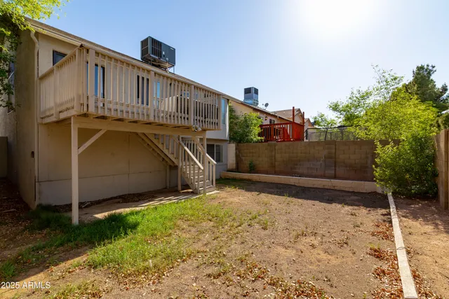 a view of a house with a wooden fence