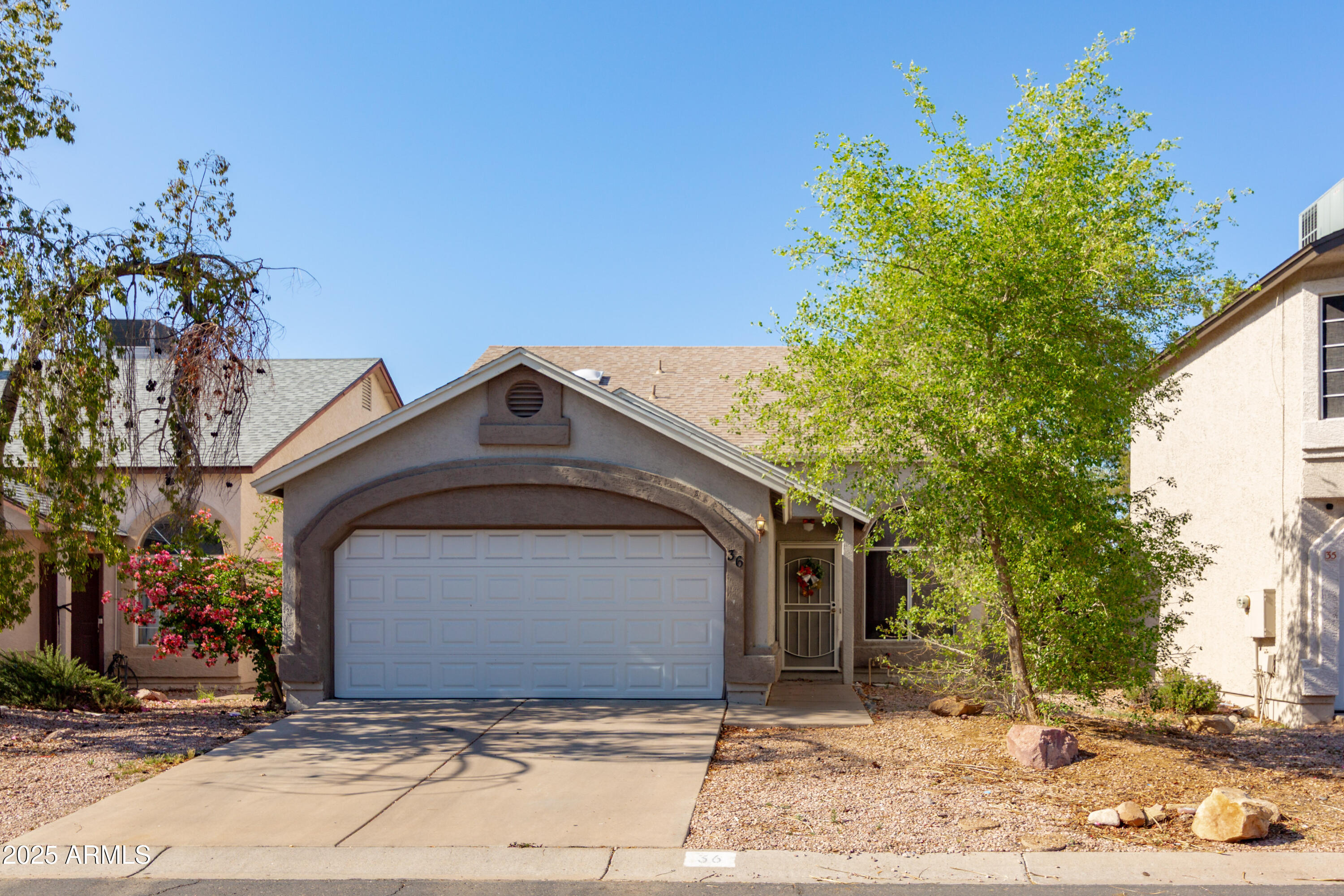 3755 East Broadway Road, Unit 36 Mesa, AZ 85206 - Photo 3 of 24 a front view of a house with a yard