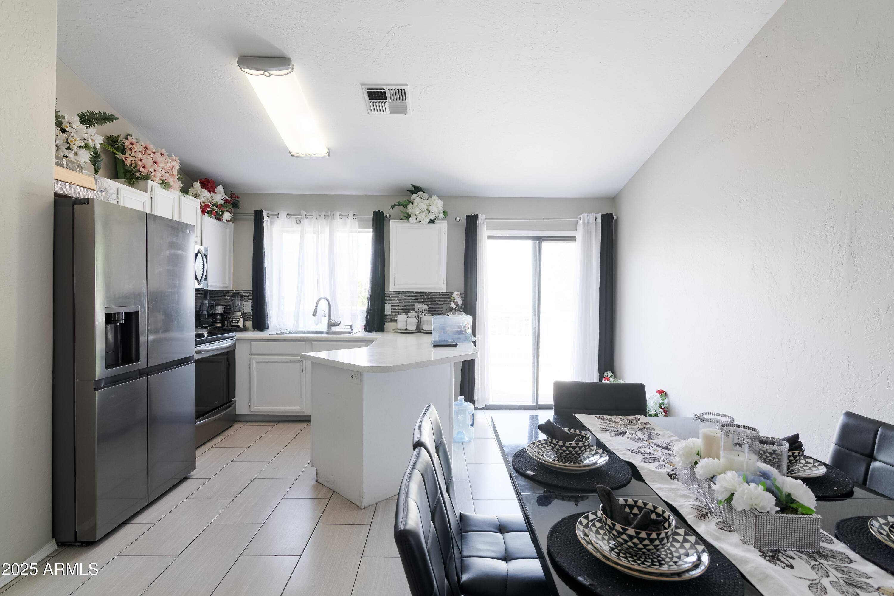 3755 East Broadway Road, Unit 36 Mesa, AZ 85206 - Photo 8 of 24 a kitchen with stainless steel appliances kitchen island granite countertop a sink and cabinets