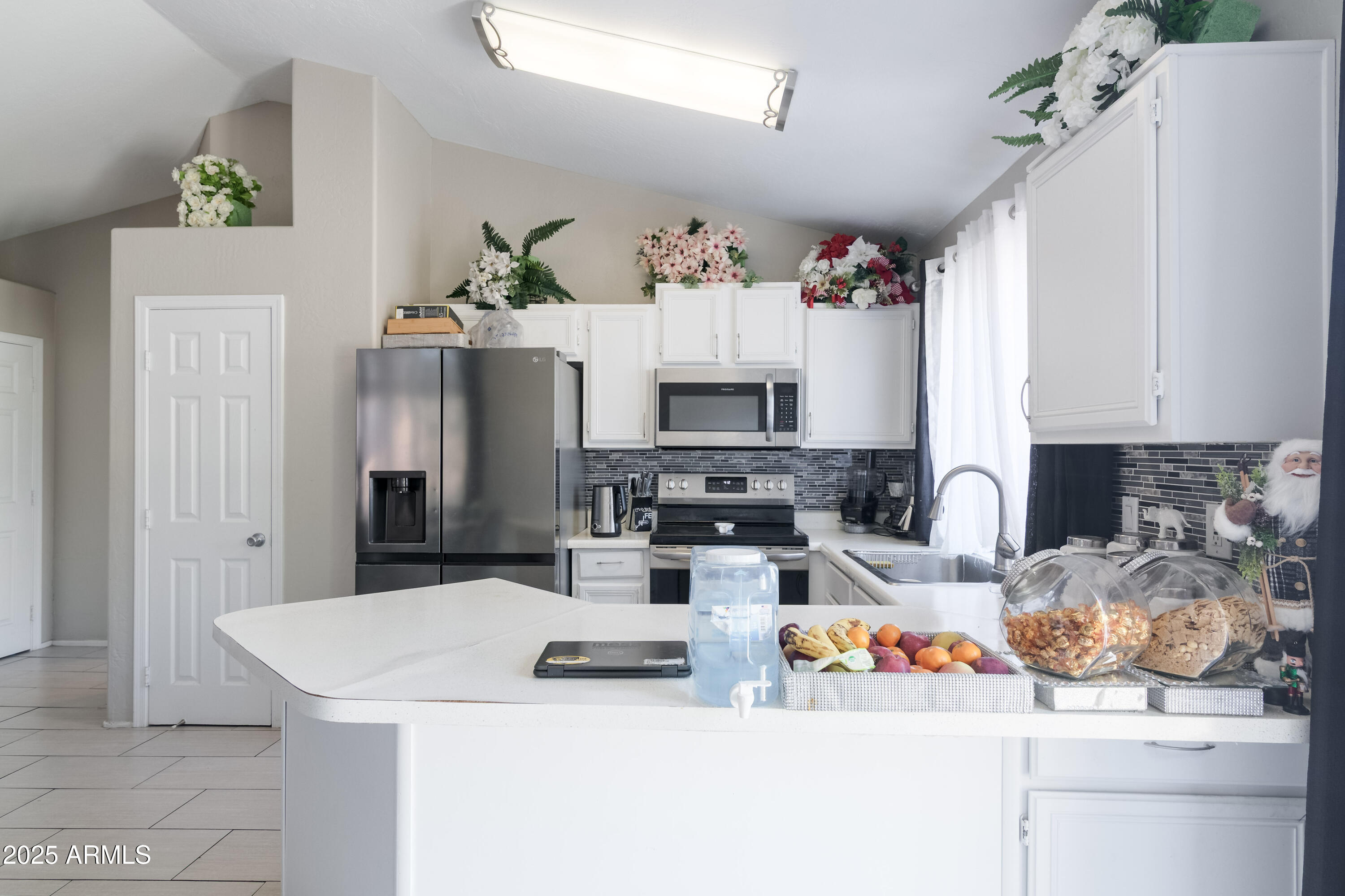 3755 East Broadway Road, Unit 36 Mesa, AZ 85206 - Photo 9 of 24 a kitchen with stainless steel appliances kitchen island granite countertop a sink a stove and a refrigerator
