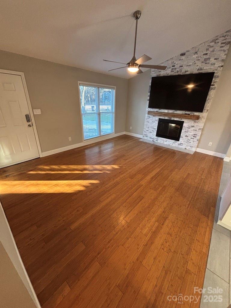 2411 Sutters Road Concord, NC 28027 - Photo 12 of 27 a view of empty room with a flat tv screen and a fireplace