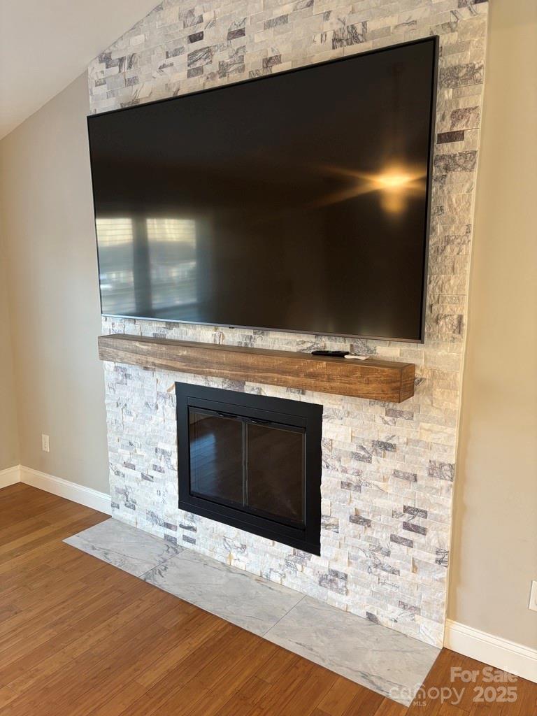 2411 Sutters Road Concord, NC 28027 - Photo 13 of 27 a fireplace with wooden floor