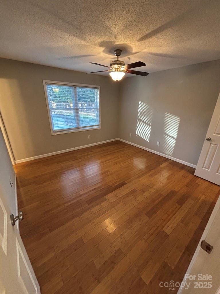 2411 Sutters Road Concord, NC 28027 - Photo 15 of 27 a view of empty room with wooden floor