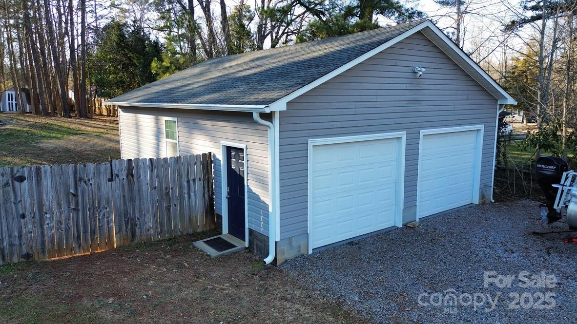 2411 Sutters Road Concord, NC 28027 - Photo 3 of 27 a view of a small house with wooden fence